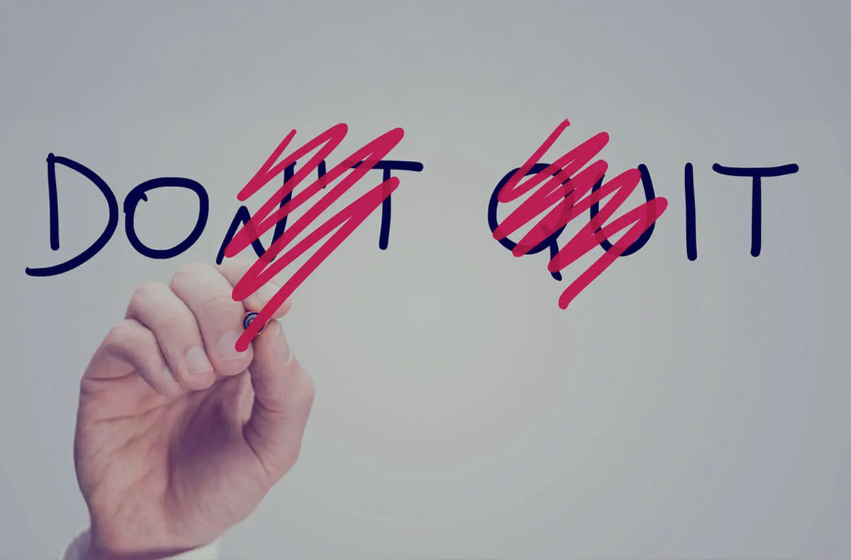 LorinNicholsonDontQuit hand with marker scrubbing out letters from 'Don't Quit' to read 'Do It'
